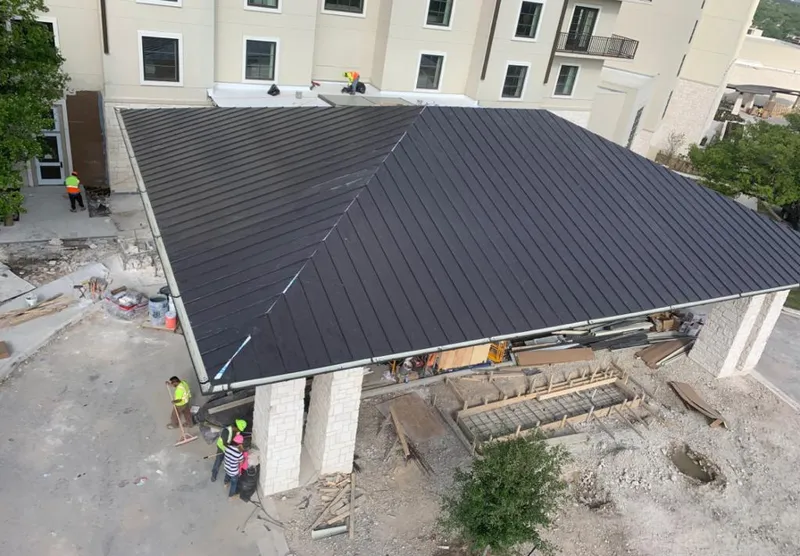 Metal roofing installation team working on a commercial building in Margaret